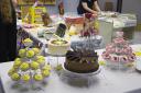 The whole display at the work luncheon, including Lemon Cupcakes, White Cake, Milk Chocolate Cake, Vanilla Candies, and Strawberry cupcakes