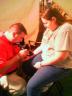 Amy gets a froggie tattoo at the Santa's World fair.