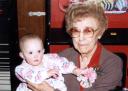 Mary holds her newest granddaughter Ashley during her daughter Diane’s wedding reception