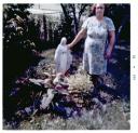 Mary poses with her freshly painted Madonna in the garden