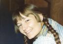 Karen smiles with long braids in her hair