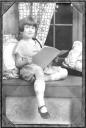 Velma poses while reading a book